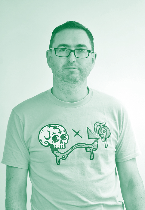Andy in a t-shirt with a graphic of a skull, arrow, and dripping shapes.